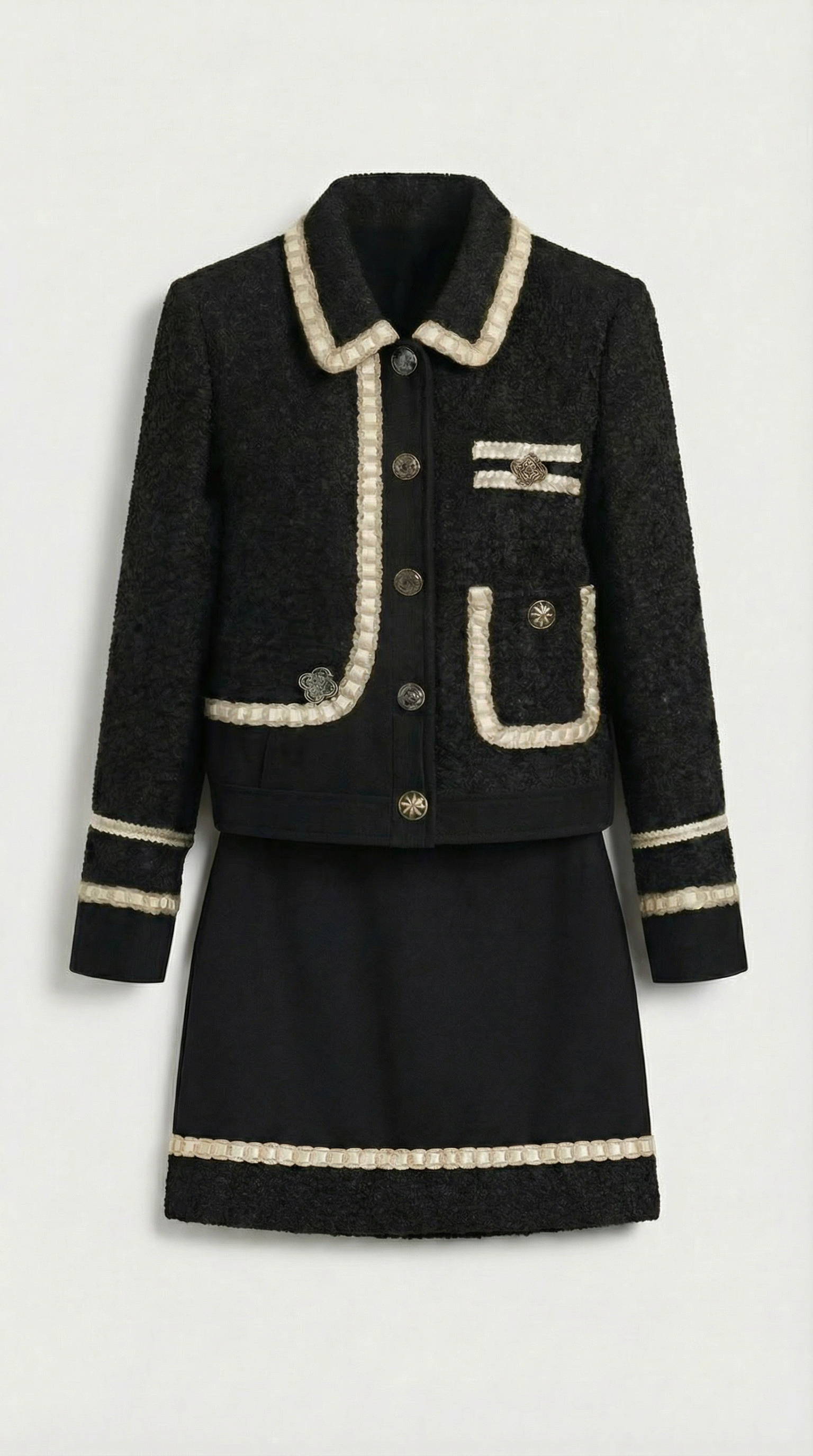 Ensemble tailleur en tweed noir Avelin, composé d'un haut et d'une mini-jupe trapèze.